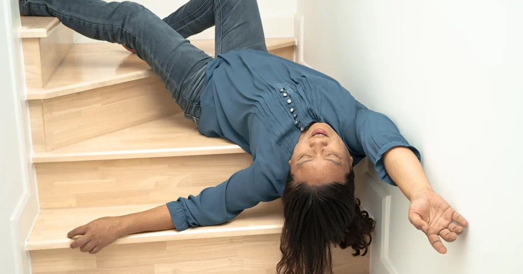 Person lying on stairs after slip and fall accident